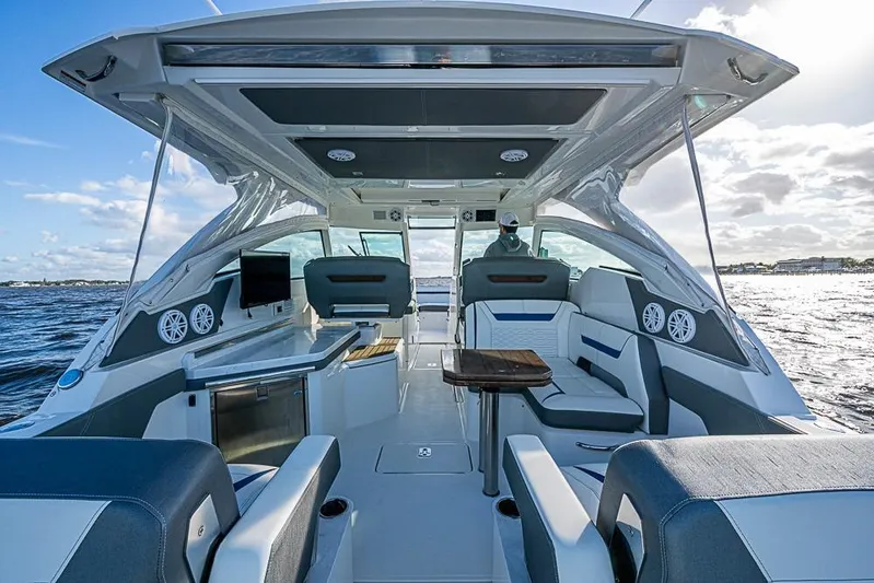 Prawn Star Yacht Photos Pics 2022 Tiara Yachts 34 LX interior with seating, table, and ocean view.