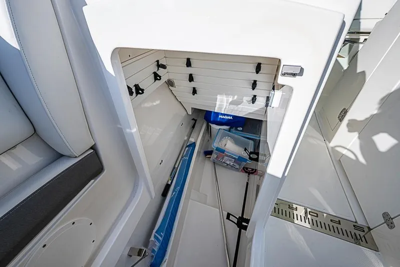 Prawn Star Yacht Photos Pics 2022 Tiara Yachts 34 LX storage compartment with fishing gear and accessories.