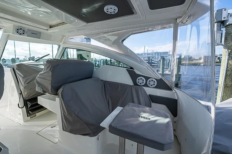 Prawn Star Yacht Photos Pics 2022 Tiara Yachts 34 LX interior with covered seating and waterfront view.