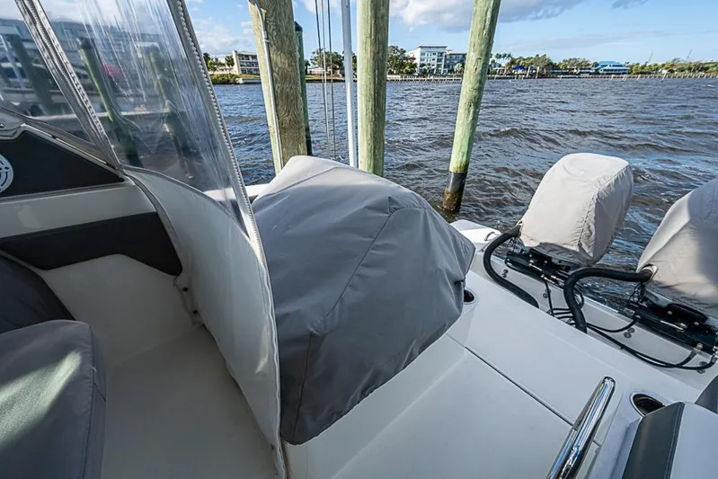 Prawn Star Yacht Photos Pics 2022 Tiara Yachts 34 LX boat interior with covered seats and water view.