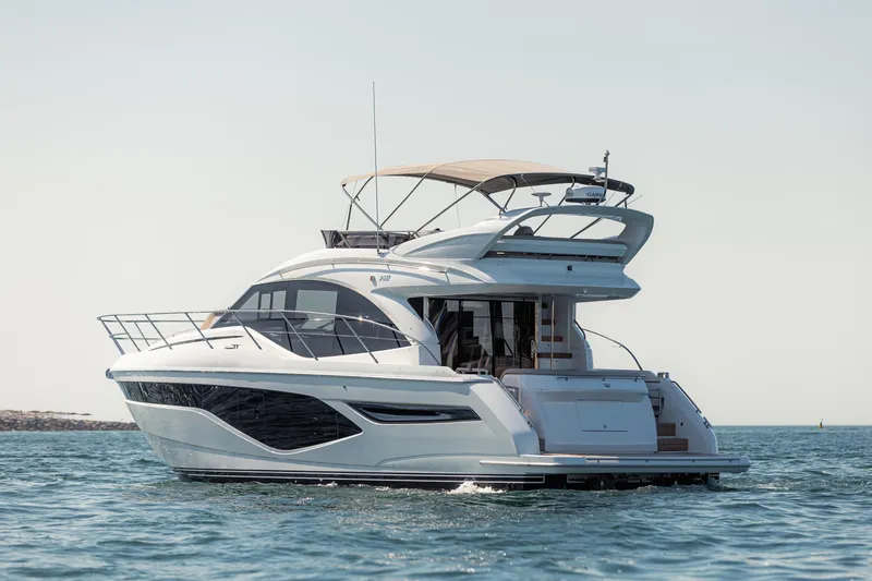  Yacht Photos Pics 2023 Princess F50 yacht cruising on open water, showcasing sleek design and luxury features.