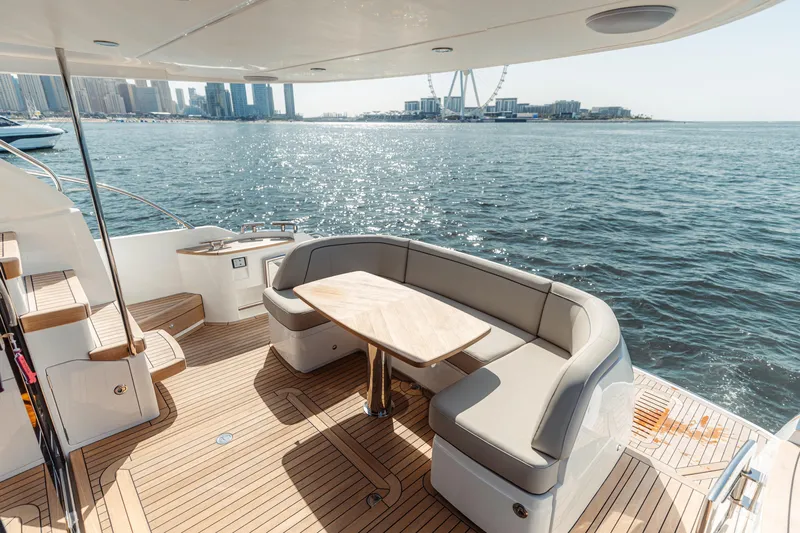  Yacht Photos Pics Luxurious 2023 Princess F50 yacht deck with elegant seating and scenic waterfront view.