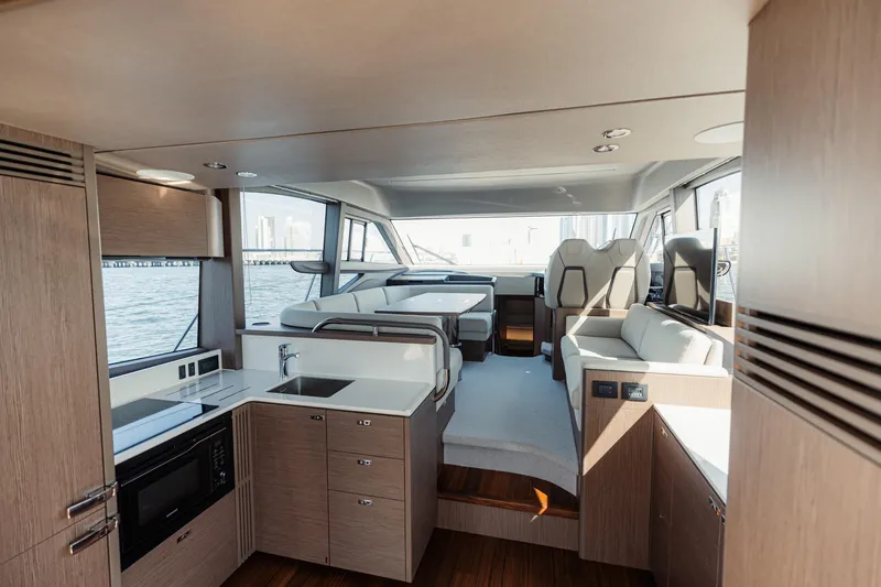  Yacht Photos Pics Luxurious interior of 2023 Princess F50 yacht with modern kitchen and seating area.