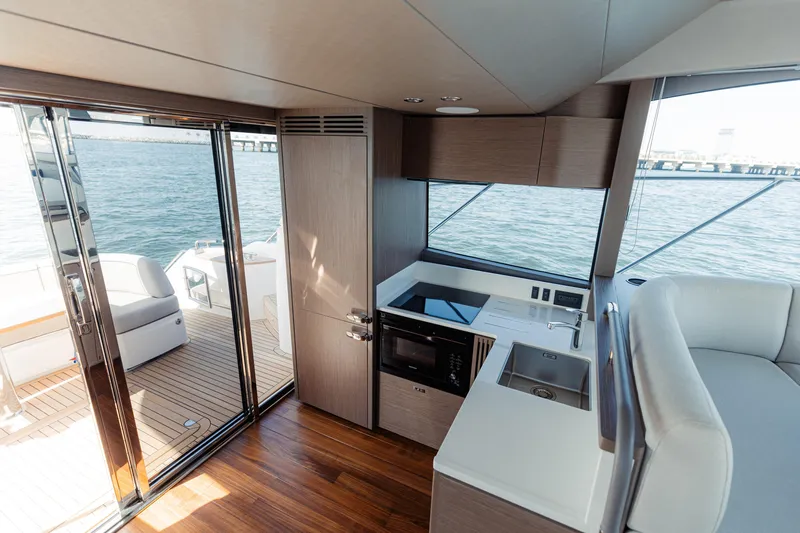  Yacht Photos Pics Luxurious interior of 2023 Princess F50 yacht with modern kitchen and ocean view.