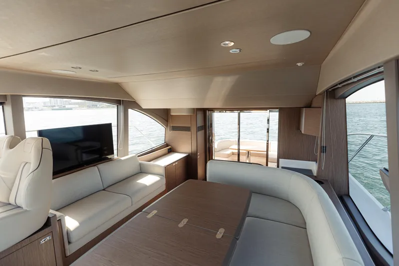  Yacht Photos Pics Luxurious interior of 2023 Princess F50 yacht with modern seating and panoramic windows.