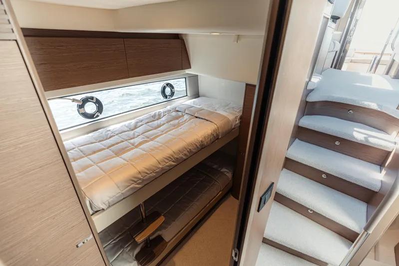  Yacht Photos Pics Luxurious 2023 Princess F50 yacht interior with cozy bunk beds and elegant staircase.
