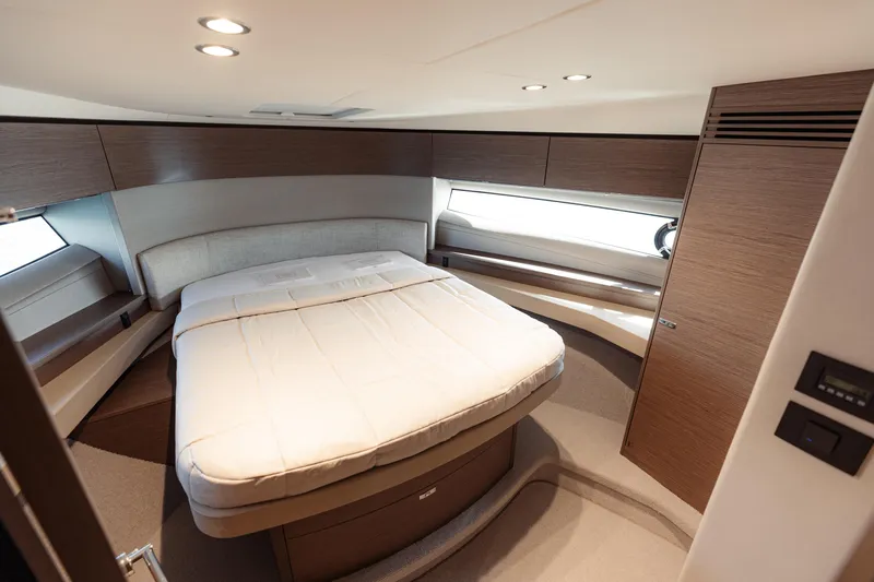  Yacht Photos Pics Luxurious cabin interior of 2023 Princess F50 yacht with modern design and cozy bed.