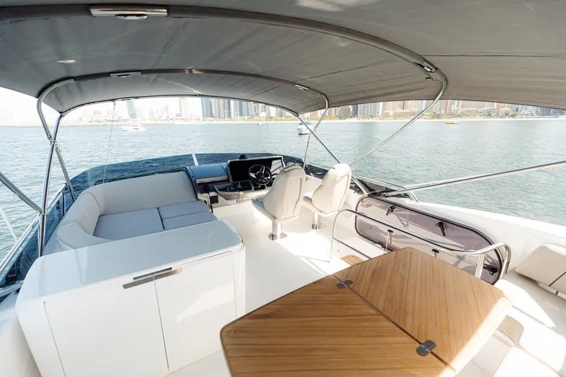  Yacht Photos Pics Luxurious 2023 Princess F50 yacht interior with seating, table, and waterfront view.