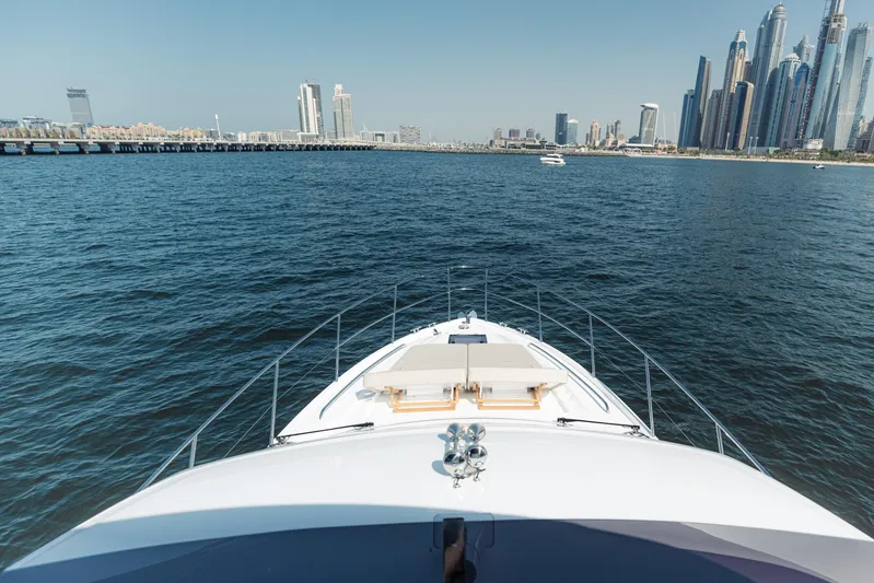  Yacht Photos Pics Bow view of 2023 Princess F50 yacht cruising near a city skyline.
