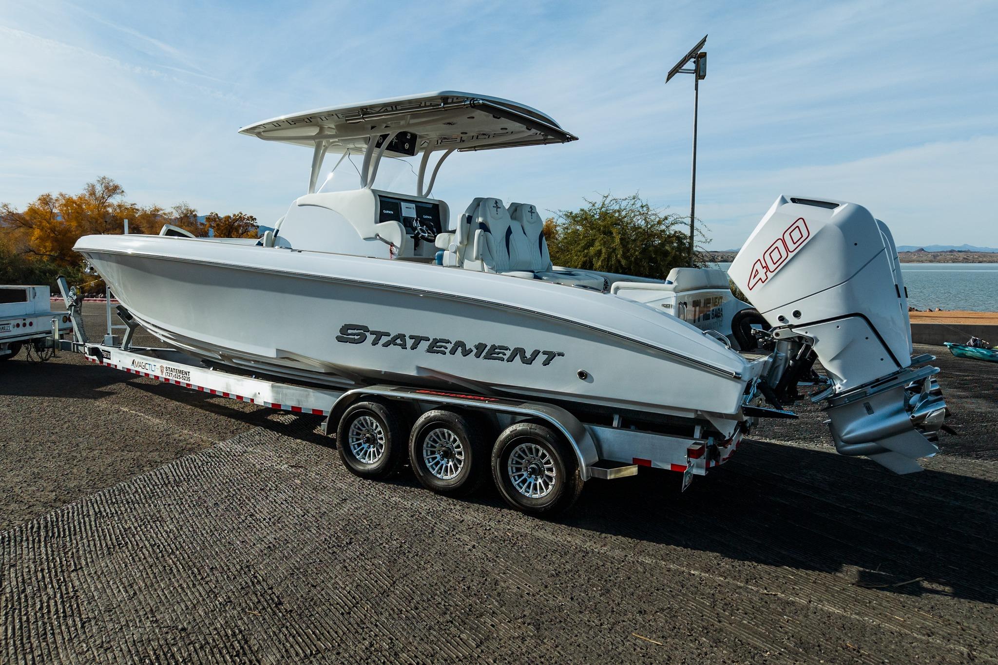2026 Statement 350 Open boat on trailer, featuring powerful 400 engine, parked near water.