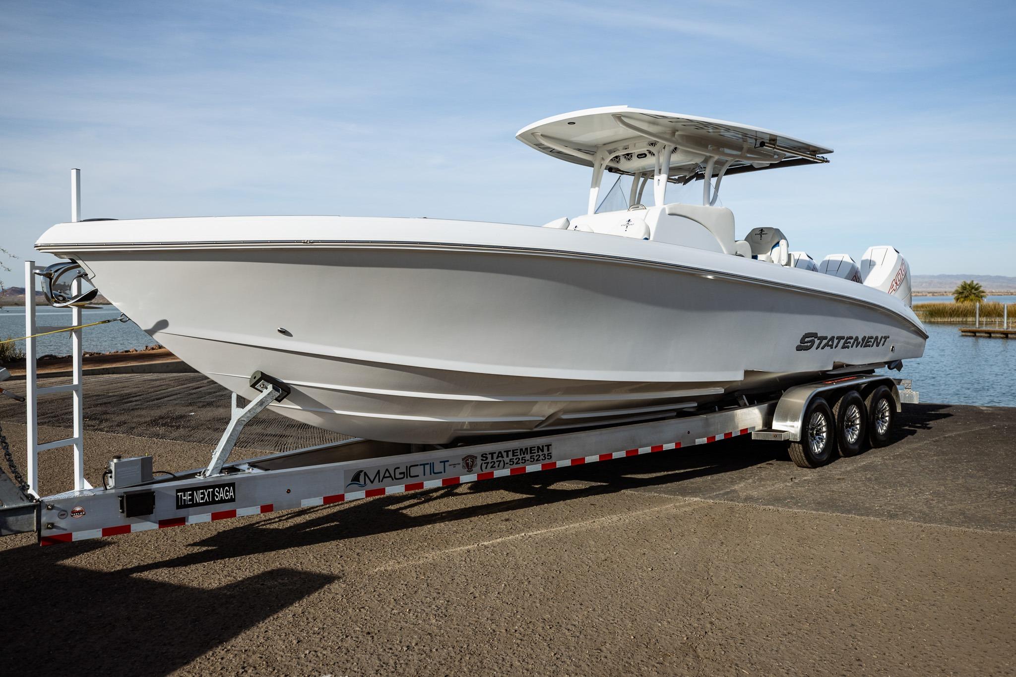 2026 Statement 350 Open boat on trailer by the water.
