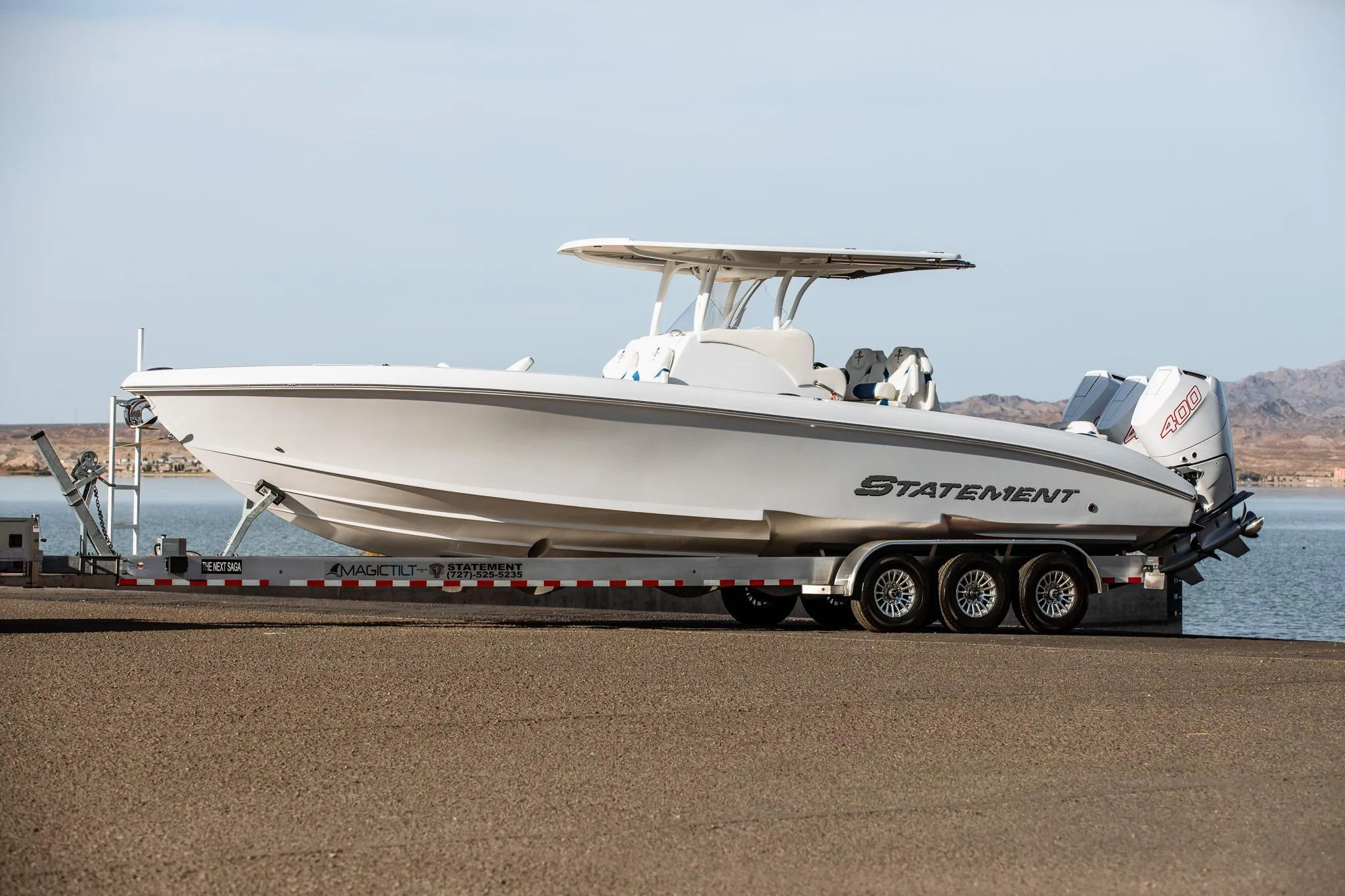 2026 Statement 350 Open boat on trailer by the water, featuring sleek design and powerful engines.