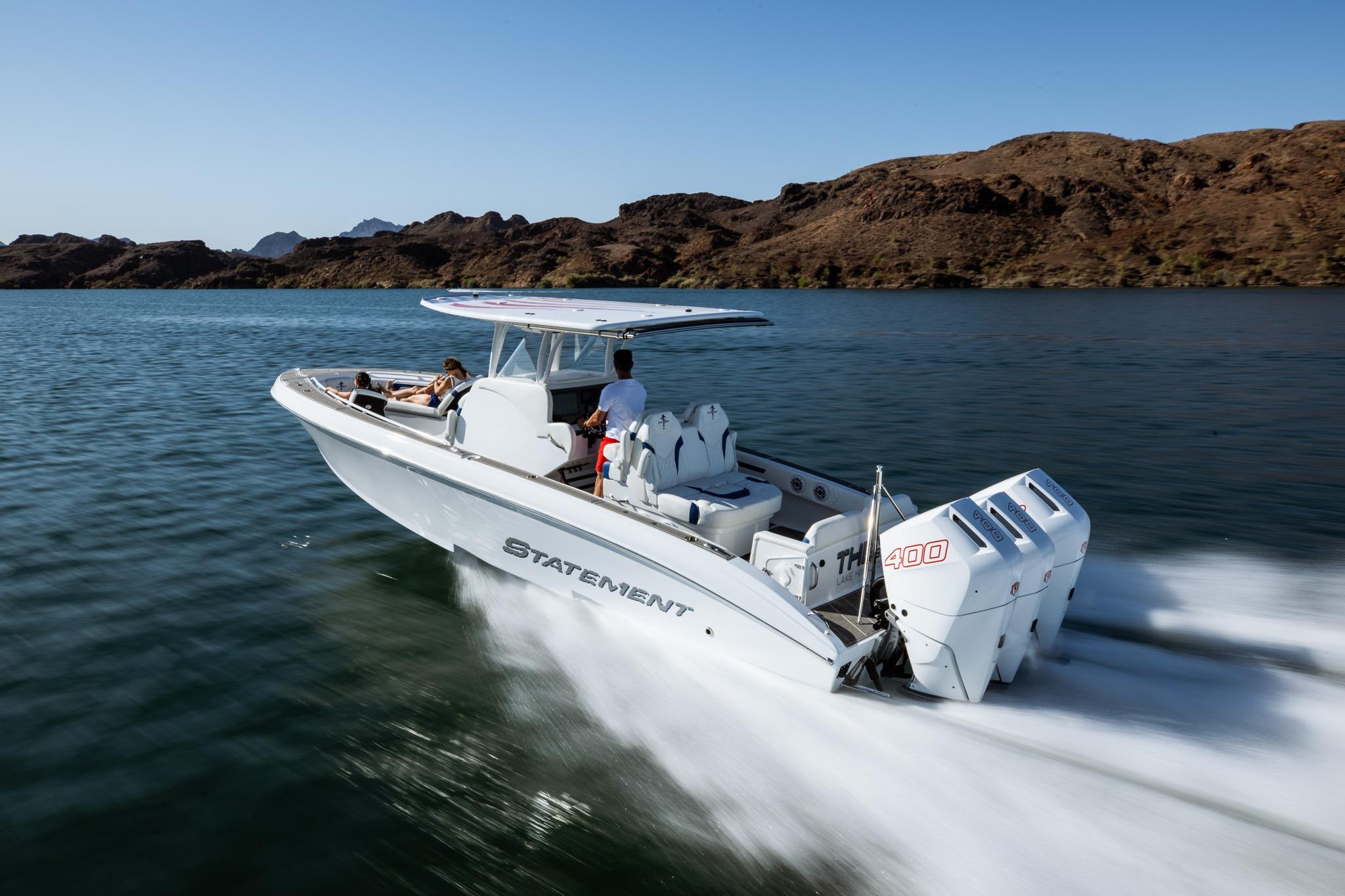 2026 Statement 350 Open boat cruising on a lake with passengers, featuring powerful engines.