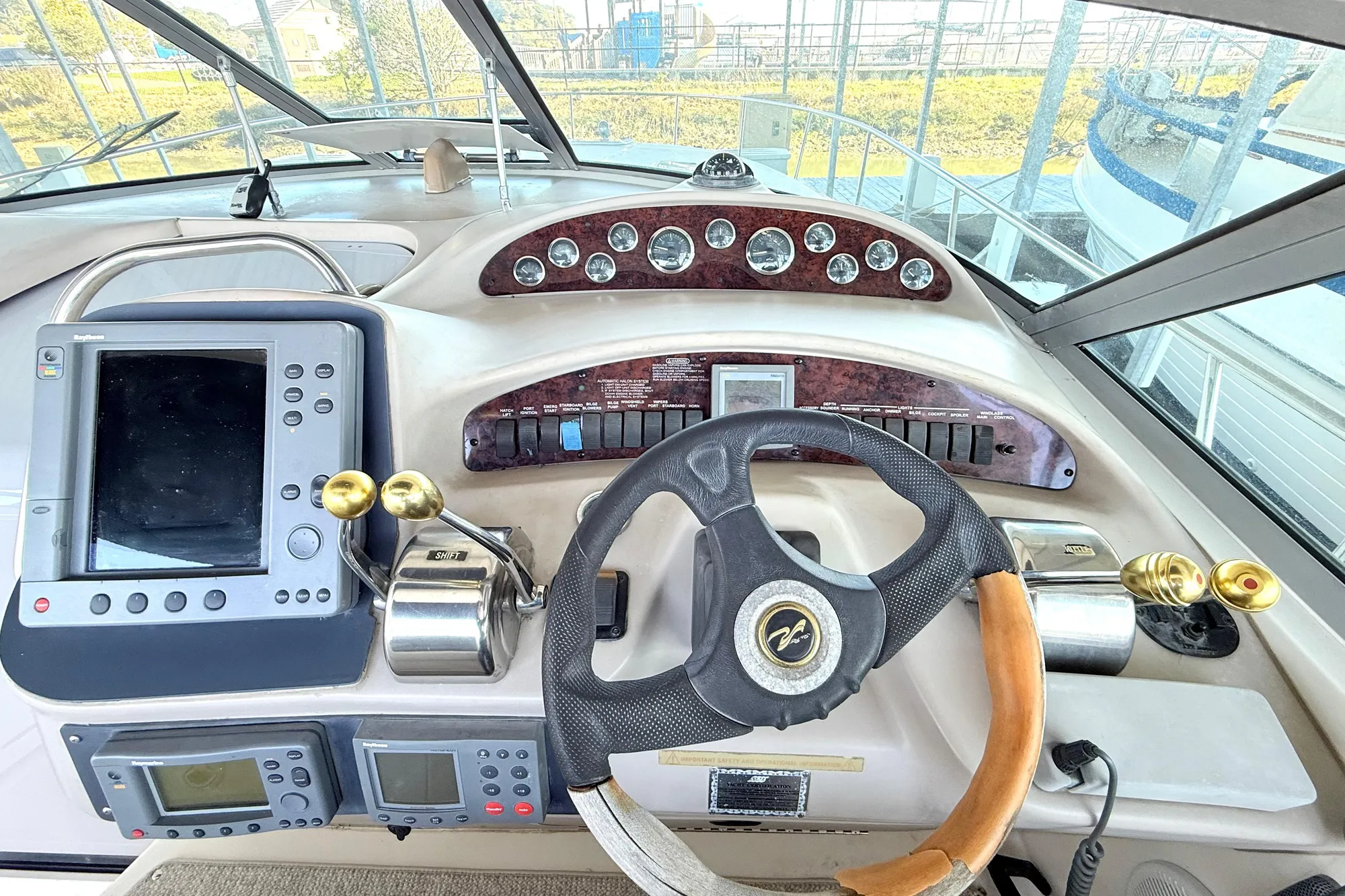 Helm of 2001 Sea Ray 340 Sundancer with steering wheel and navigation controls.