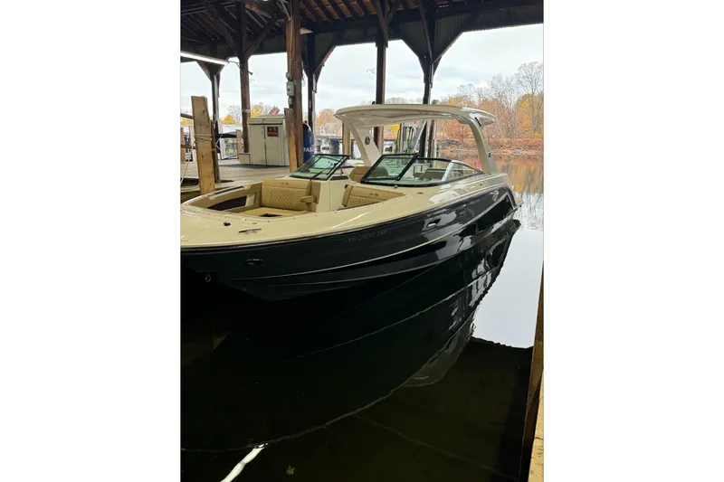  Yacht Photos Pics 2019 Sea Ray SLX 310 Outboard boat docked under a wooden shelter.