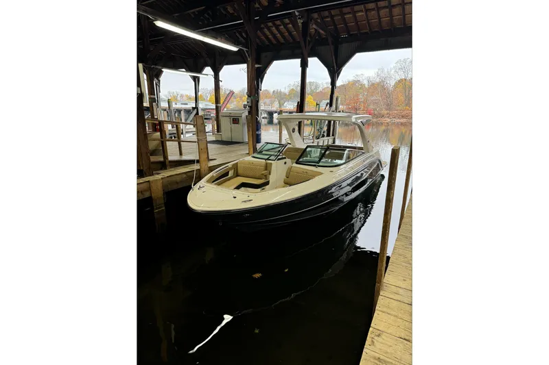  Yacht Photos Pics 2019 Sea Ray SLX 310 Outboard docked in a covered marina.