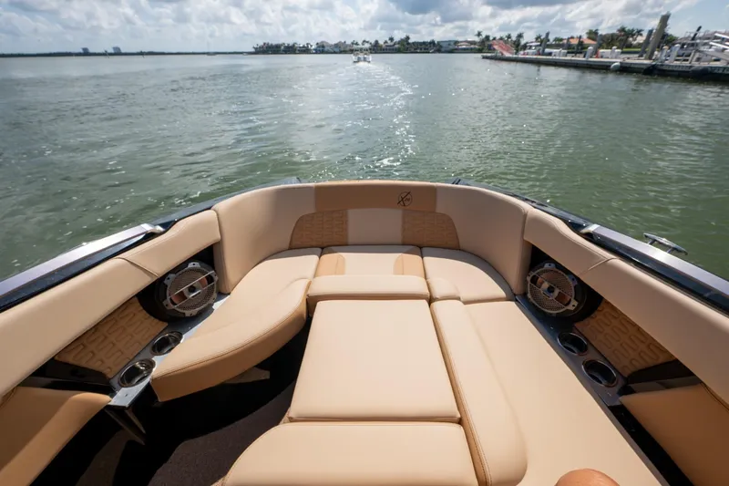  Yacht Photos Pics Luxurious 2022 MasterCraft X26 boat interior with tan seating on a sunny day.