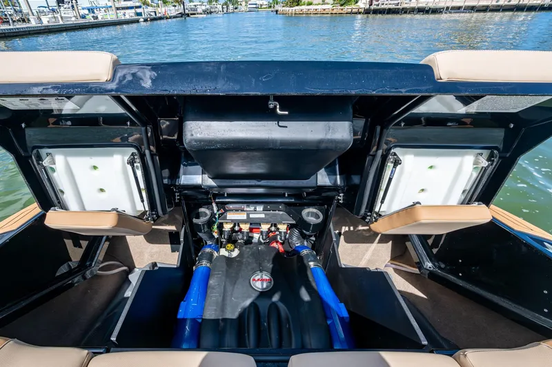  Yacht Photos Pics 2022 MasterCraft X26 boat engine compartment with open hatches, dockside view.