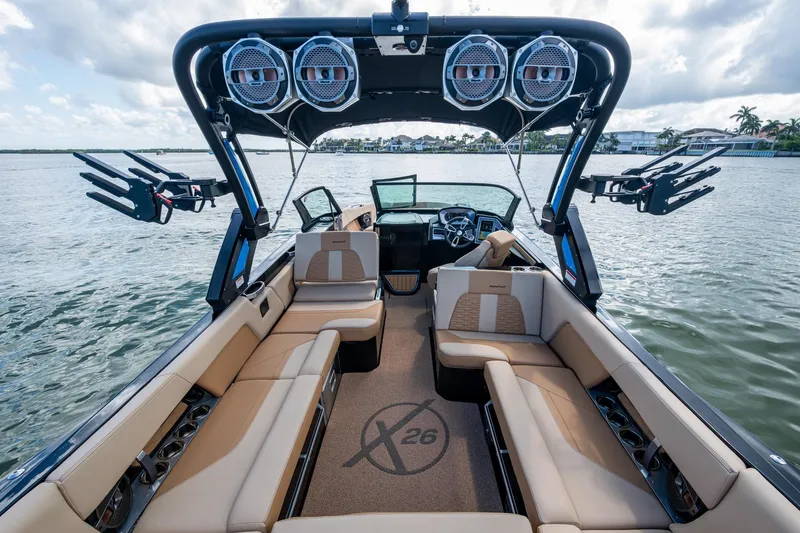  Yacht Photos Pics 2022 MasterCraft X26 boat interior with luxurious seating and advanced audio system on the water.