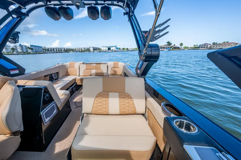  Yacht Photos Pics 2022 MasterCraft X26 boat interior with luxurious seating on a sunny day.
