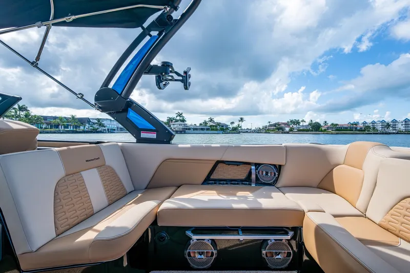  Yacht Photos Pics 2022 MasterCraft X26 boat interior with luxurious seating and scenic waterfront view.