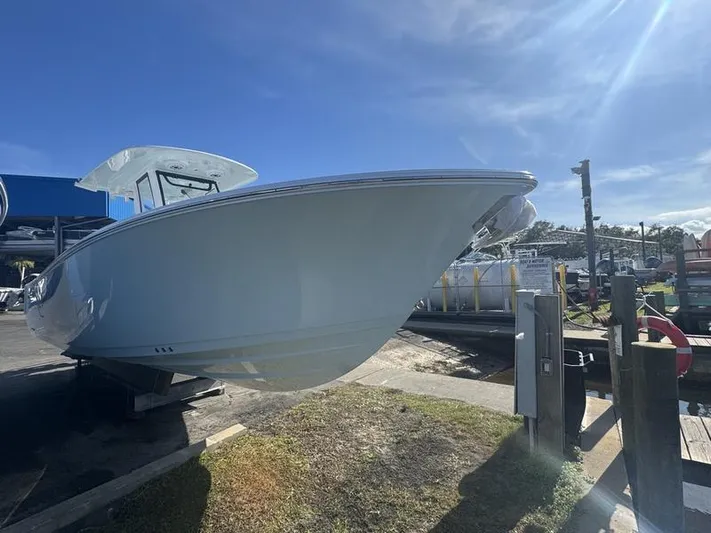  Yacht Photos Pics 2025 Sportsman Heritage 26 boat on dry dock under clear blue sky.