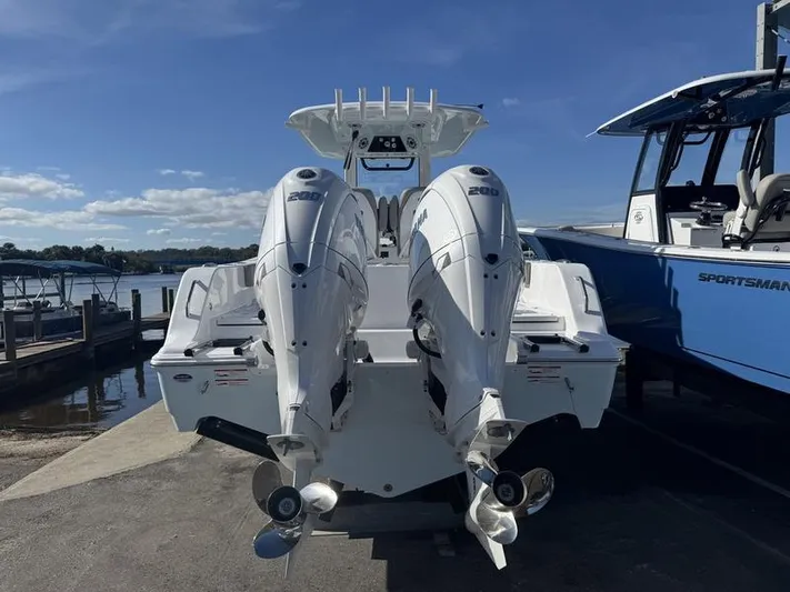  Yacht Photos Pics 2025 Sportsman Heritage 26 boat with dual outboard engines at a marina.