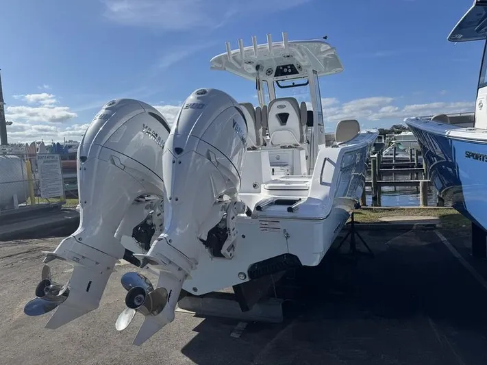  Yacht Photos Pics 2025 Sportsman Heritage 26 boat with dual outboard engines docked under clear skies.