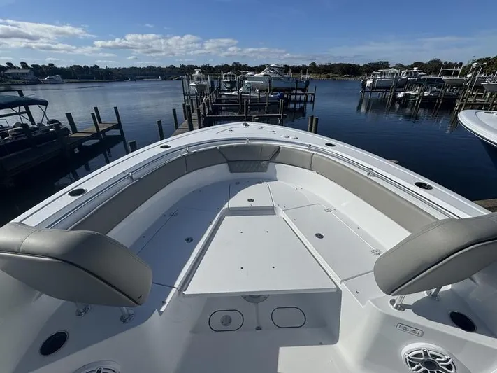  Yacht Photos Pics 2025 Sportsman Heritage 26 boat docked at a marina, featuring spacious seating and calm waters.