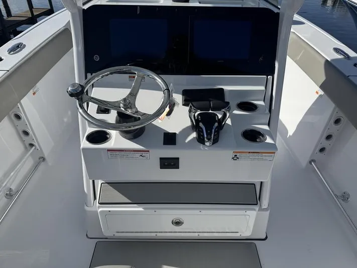  Yacht Photos Pics 2025 Sportsman Heritage 26 boat console with steering wheel and dual screens.