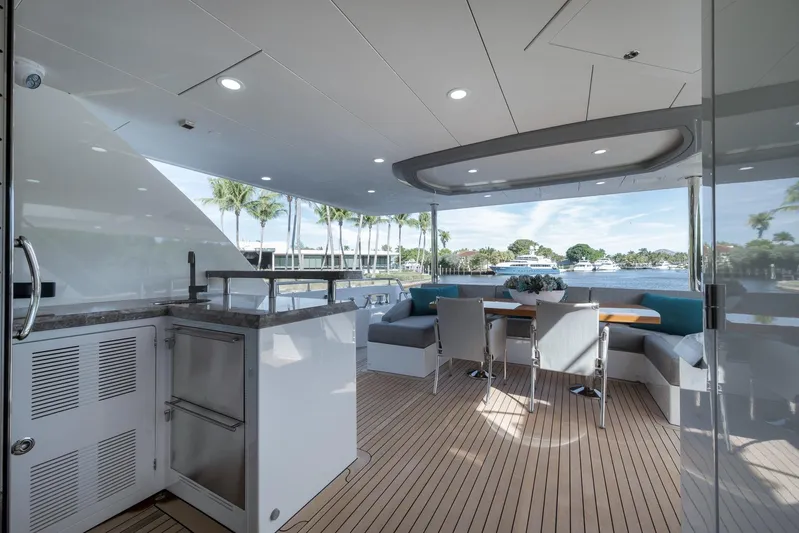 Live Mas Yacht Photos Pics Luxurious 2017 Ocean Alexander 85 E yacht deck with elegant seating and scenic waterfront view.