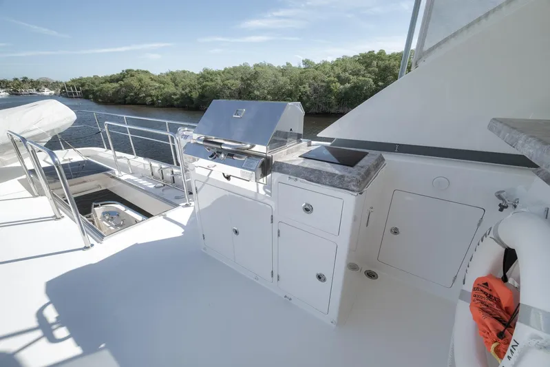 Live Mas Yacht Photos Pics Outdoor kitchen on 2017 Ocean Alexander 85 E yacht with grill and storage, near waterway.