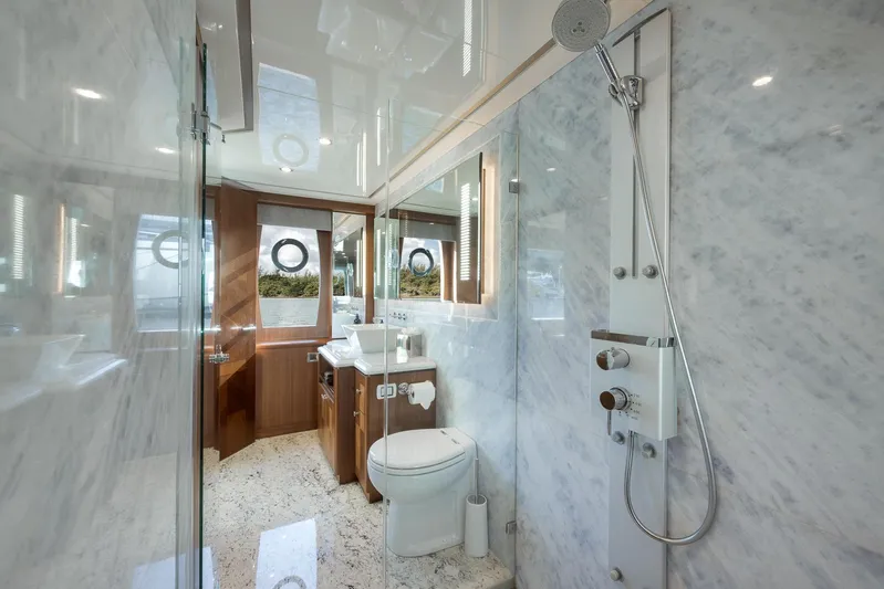 Live Mas Yacht Photos Pics Luxurious bathroom on 2017 Ocean Alexander 85 E yacht with marble walls and modern fixtures.