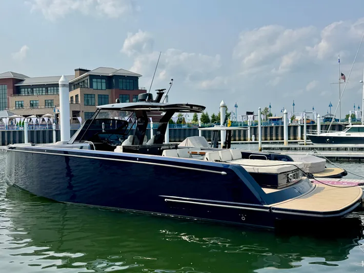  Yacht Photos Pics 2021 Pardo Yachts 43 docked at a marina, sleek design, modern architecture in background.