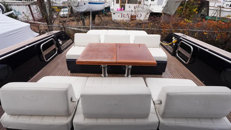  Yacht Photos Pics 2021 Pardo Yachts P43 interior with white seating and wooden table.