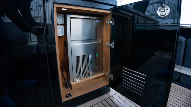 Yacht Photos Pics 2021 Pardo Yachts P43 interior showing a built-in stainless steel appliance in a wooden cabinet.