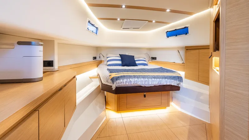  Yacht Photos Pics Luxurious cabin interior of 2021 Pardo Yachts P43, featuring modern design and cozy bedding.
