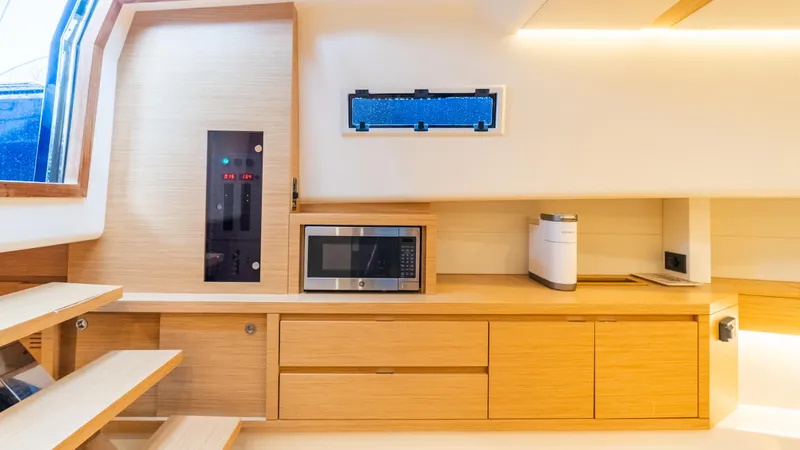  Yacht Photos Pics Modern interior of 2021 Pardo Yachts P43 with wooden cabinetry and built-in microwave.