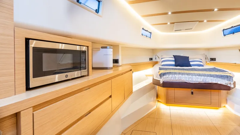  Yacht Photos Pics Luxurious interior of 2021 Pardo Yachts P43 with modern amenities and cozy sleeping area.