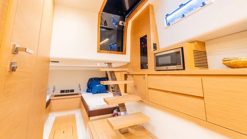  Yacht Photos Pics Interior of 2021 Pardo Yachts P43, featuring modern wood finishes and compact kitchen area.