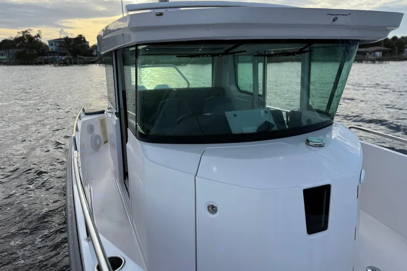  Yacht Photos Pics 2022 Axopar 28 Cabin boat on water at sunset.