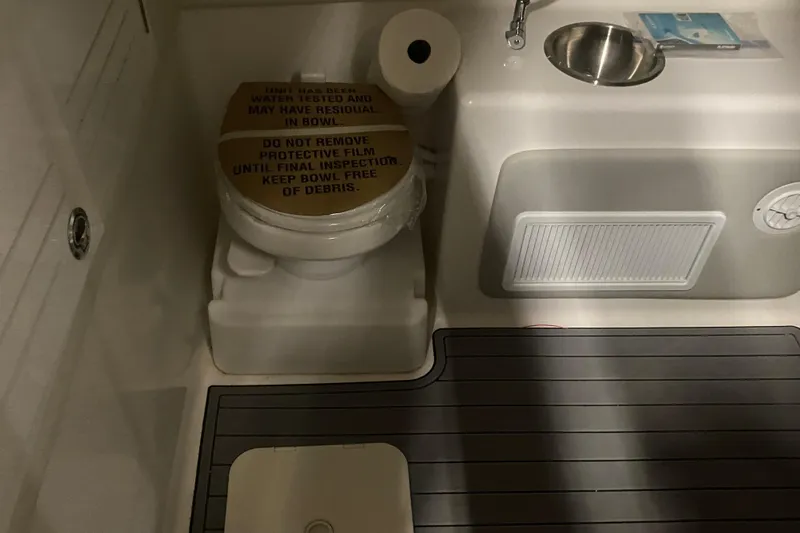  Yacht Photos Pics 2022 Front Runner 39 CC boat bathroom with toilet, sink, and protective film.