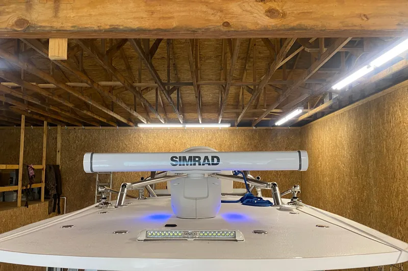  Yacht Photos Pics 2022 Front Runner 39 CC boat with Simrad radar in a wooden garage.