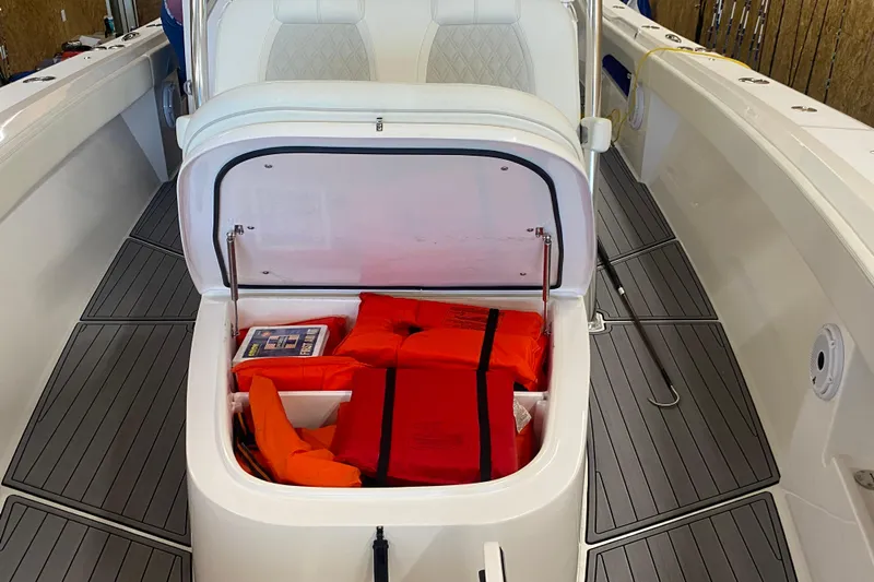  Yacht Photos Pics 2022 Front Runner 39 CC boat with open storage compartment containing life jackets.