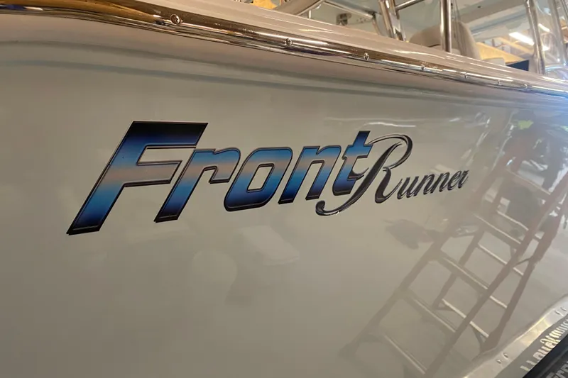  Yacht Photos Pics 2022 Front Runner 39 CC boat logo on sleek hull surface.