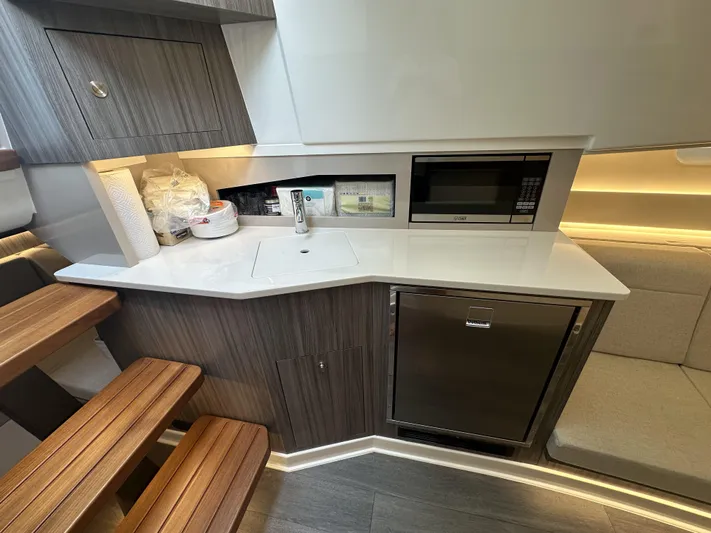 37 Sea Ray Sundancer Ob 2023 Yacht Photos Pics Modern kitchen area in 2023 Sea Ray Sundancer 370 OB yacht with sleek cabinetry and appliances.