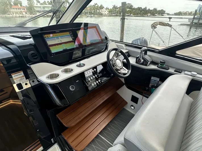 37 Sea Ray Sundancer Ob 2023 Yacht Photos Pics 2023 Sea Ray Sundancer 370 OB helm with modern controls and waterfront view.