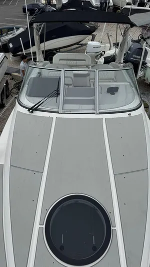  Yacht Photos Pics 2024 Regal 26 XO boat with sleek design and spacious deck, docked among other boats.