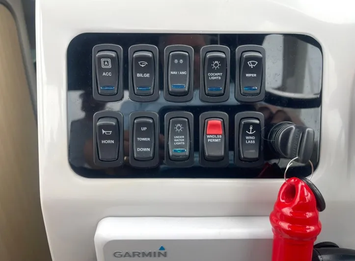  Yacht Photos Pics Control panel of 2024 Regal 26 XO boat with labeled switches and Garmin device.