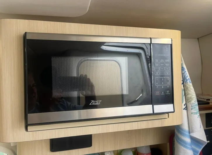  Yacht Photos Pics Microwave oven inside a 2024 Regal 26 XO boat kitchen area.